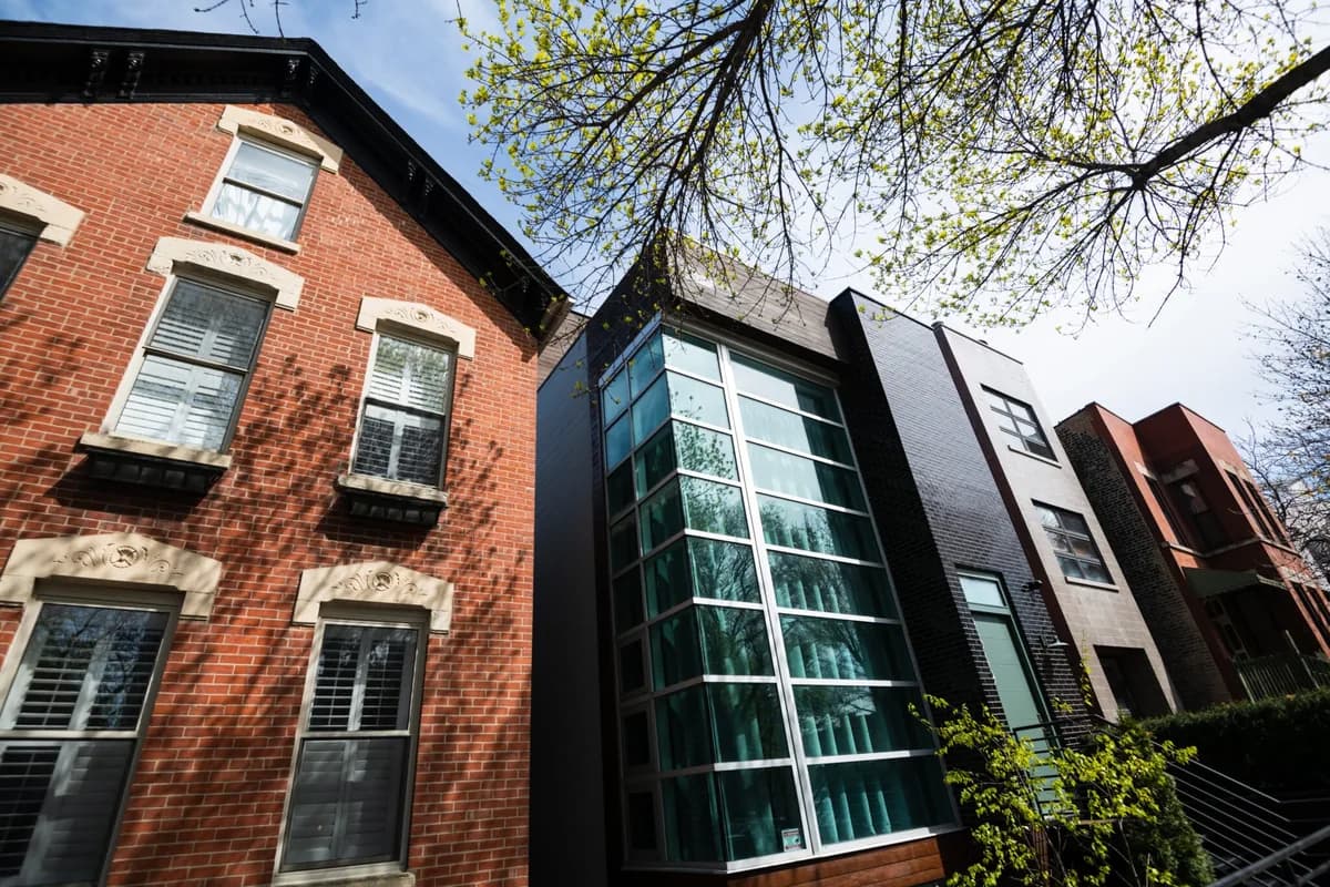 Modern residential buildings with clean glass windows and brick exterior facades