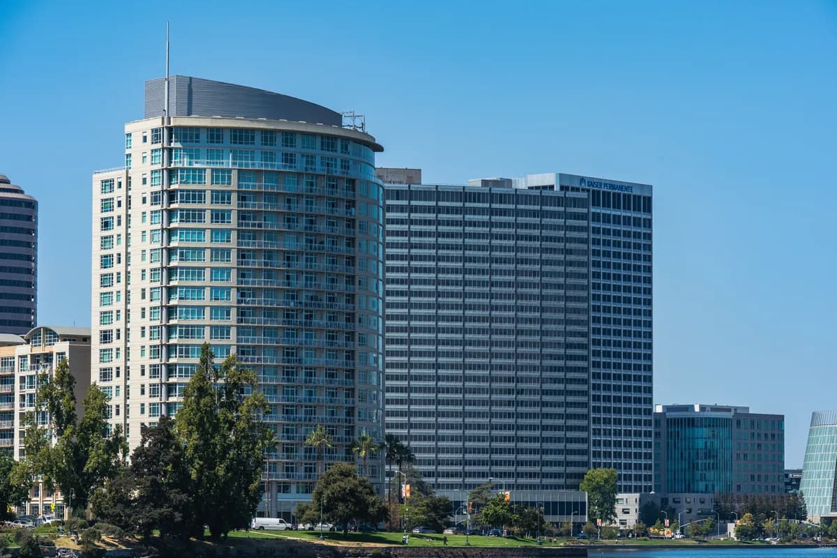 Modern multi-story residential and office buildings with extensive glass windows and clear facades