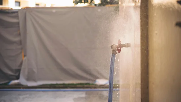 Water spraying from outdoor faucet valve during cleaning operation