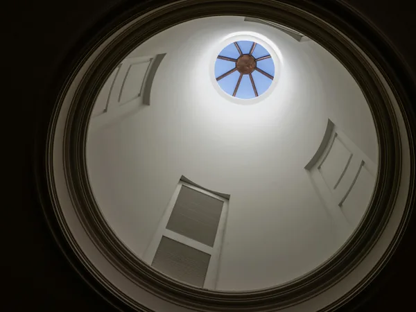 Circular dome ceiling with central skylight and architectural details