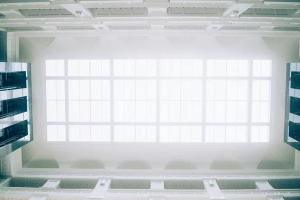 Bright skylight with gridded glass panels in modern interior ceiling