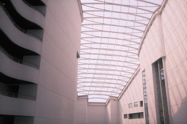 Modern atrium with glass skylights and curved architectural walls