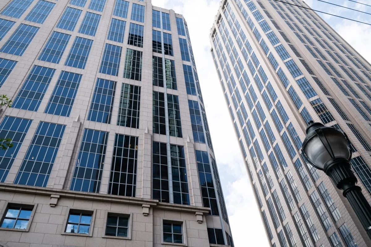 Modern skyscrapers with extensive glass windows and blue reflective panels