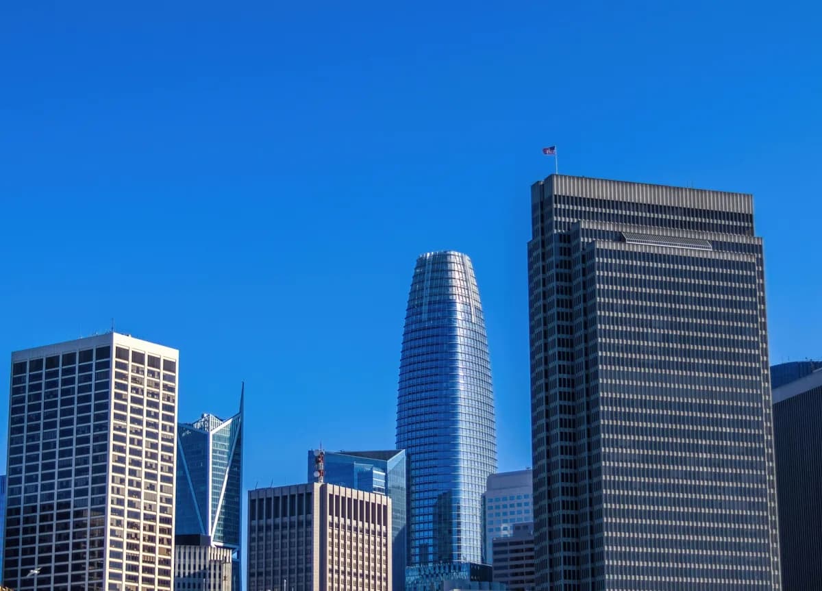 Modern skyscrapers with reflective glass facades against clear blue sky