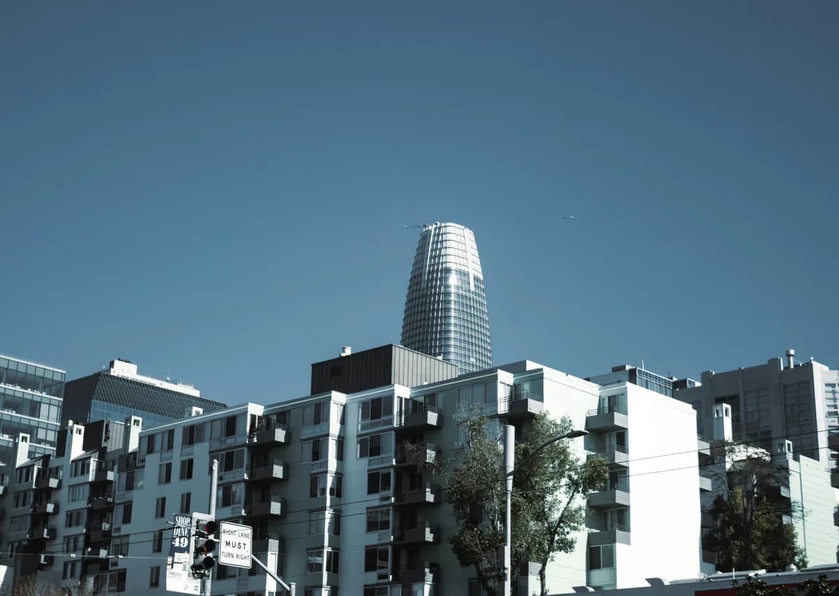 Modern residential and commercial buildings with clean glass windows under clear sky