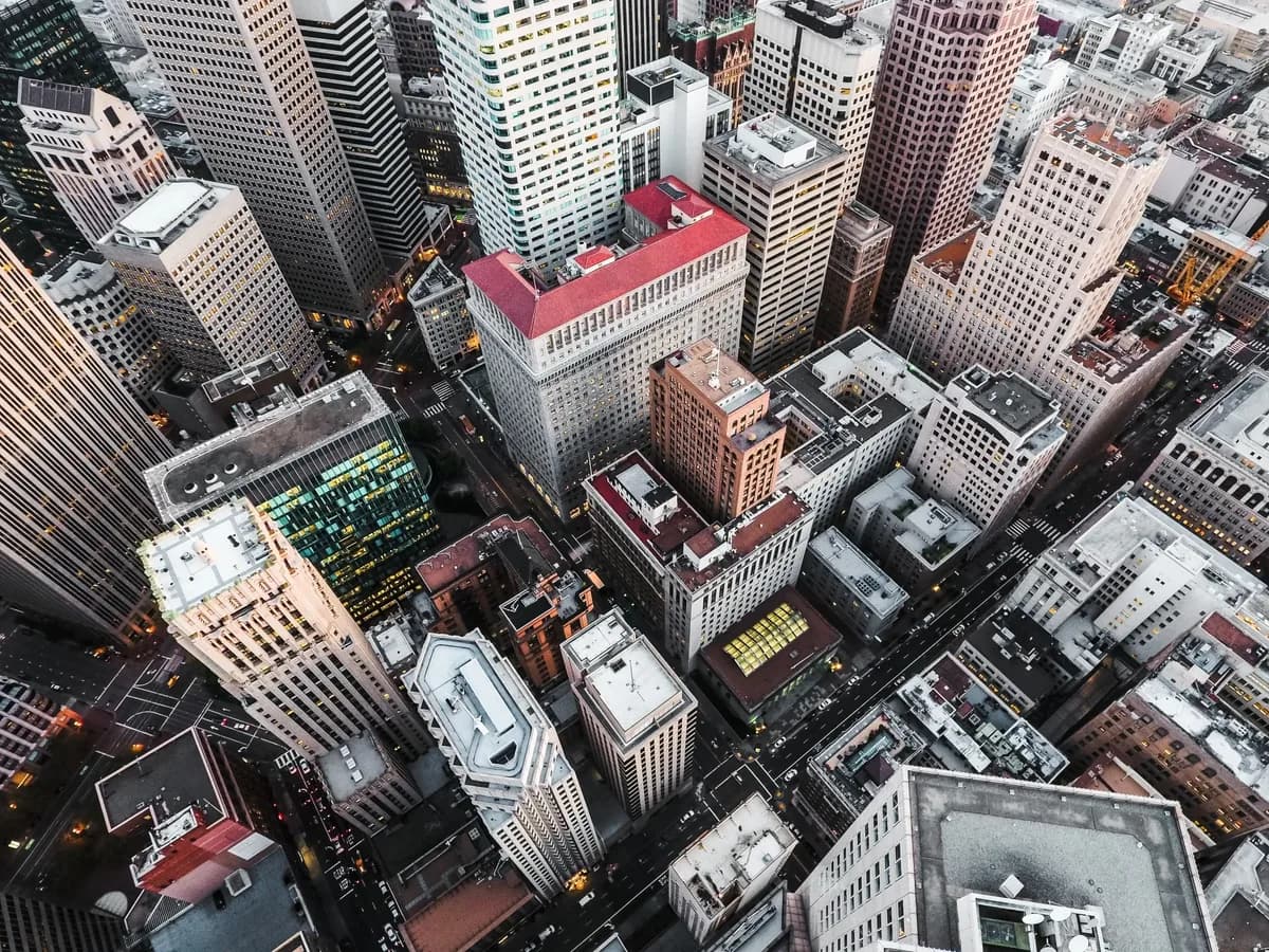 Aerial view of urban downtown buildings with various window styles and rooftops