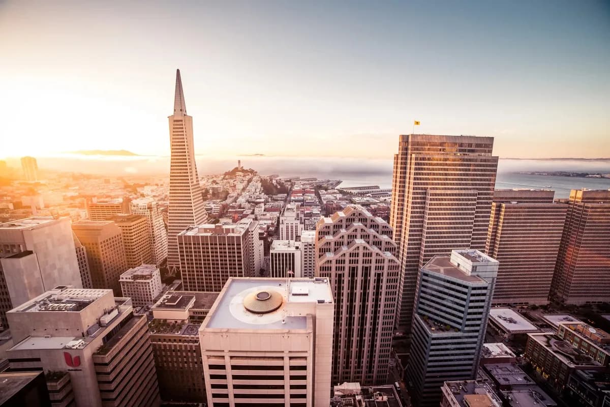 Aerial cityscape view of downtown skyscrapers and office building exteriors at sunset