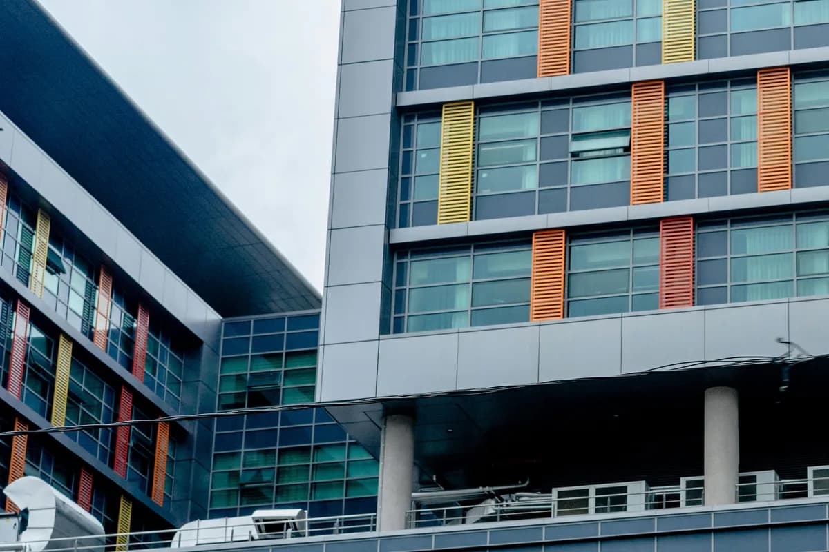 Modern multi-story building with large windows and colorful exterior panels