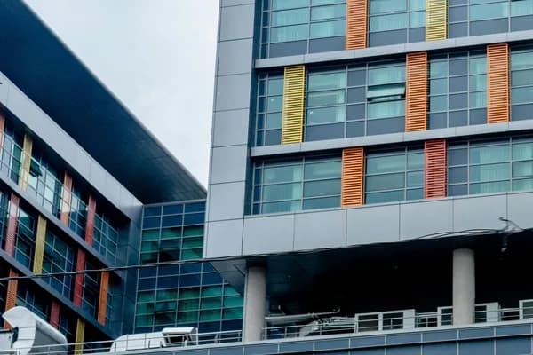 Modern multi-story building with large windows and colorful exterior panels