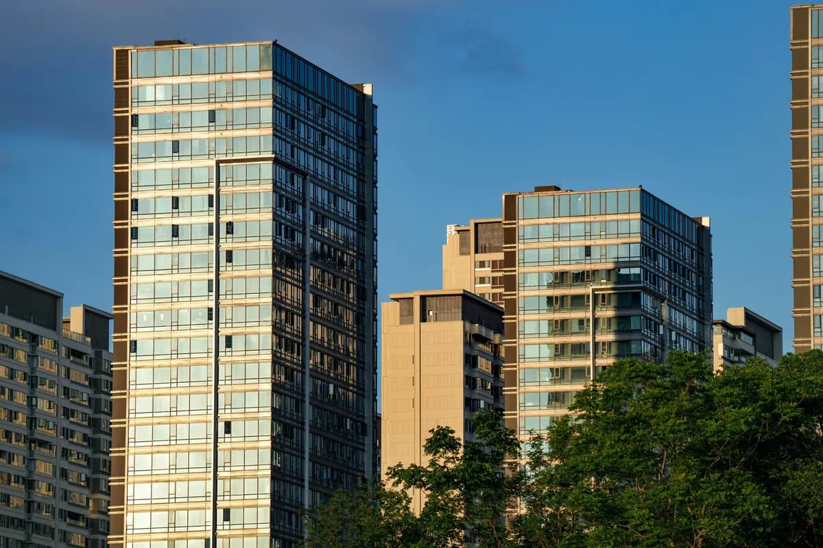 Modern high-rise residential buildings with extensive glass windows and facades