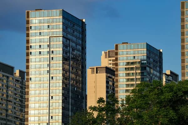 Modern high-rise residential buildings with extensive glass windows and facades