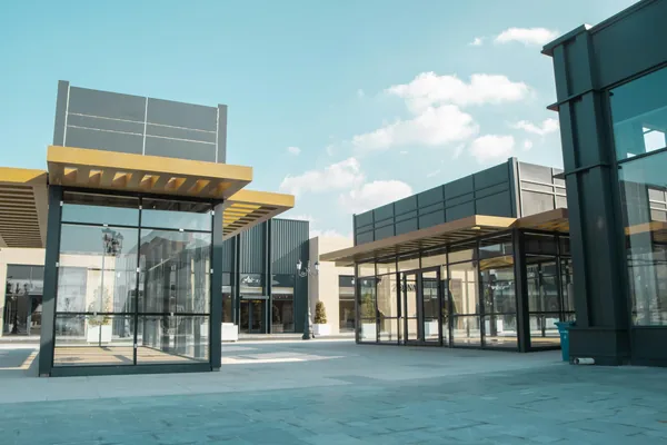 Modern commercial building exterior with large glass windows and clean facade