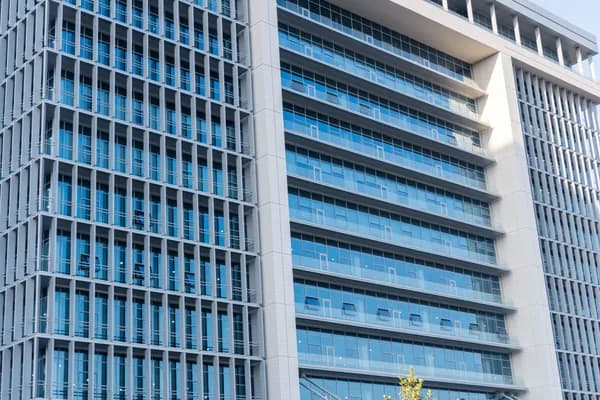 Modern high-rise building with extensive glass windows and clean exterior facade