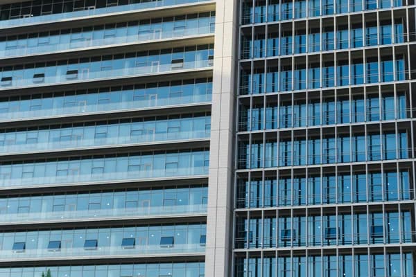Modern high-rise office building with extensive glass windows and clean facade