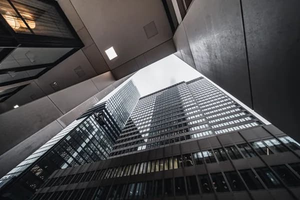 Upward view of modern skyscraper glass and steel exterior with windows