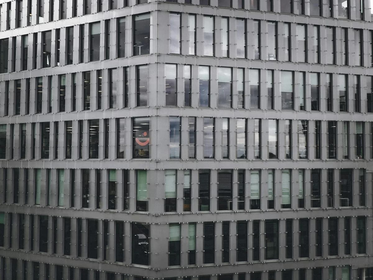 Modern glass curtain wall building with reflective windows and metal framing