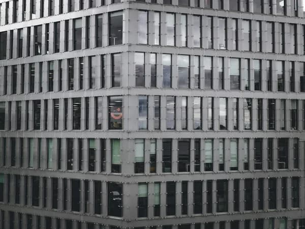 Modern glass curtain wall building with reflective windows and metal framing