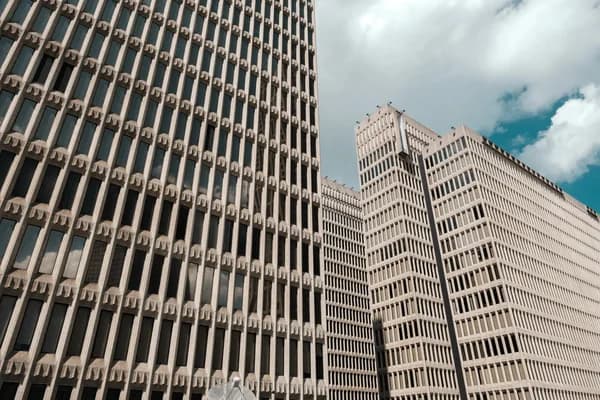 Modern office building facades with repetitive window patterns and glass exterior