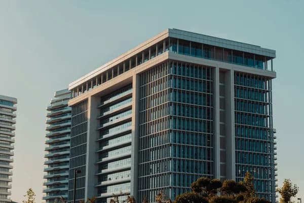Modern high-rise residential building with reflective glass windows and balconies