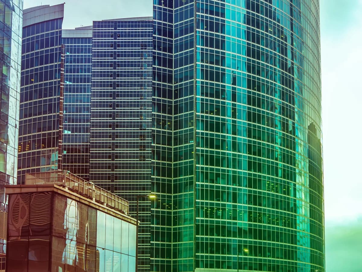 Modern skyscrapers with glass and gridded window facades in urban downtown