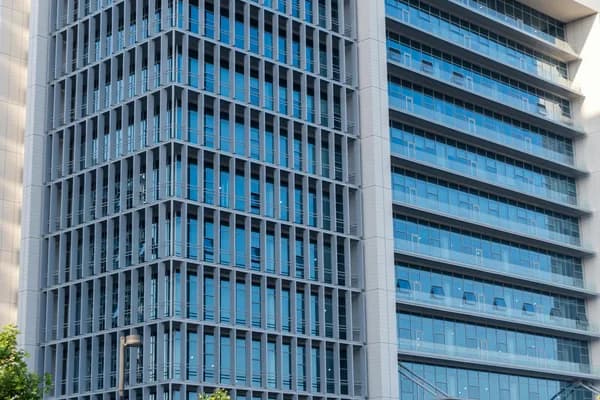Modern high-rise building with extensive glass windows and metal framing exterior