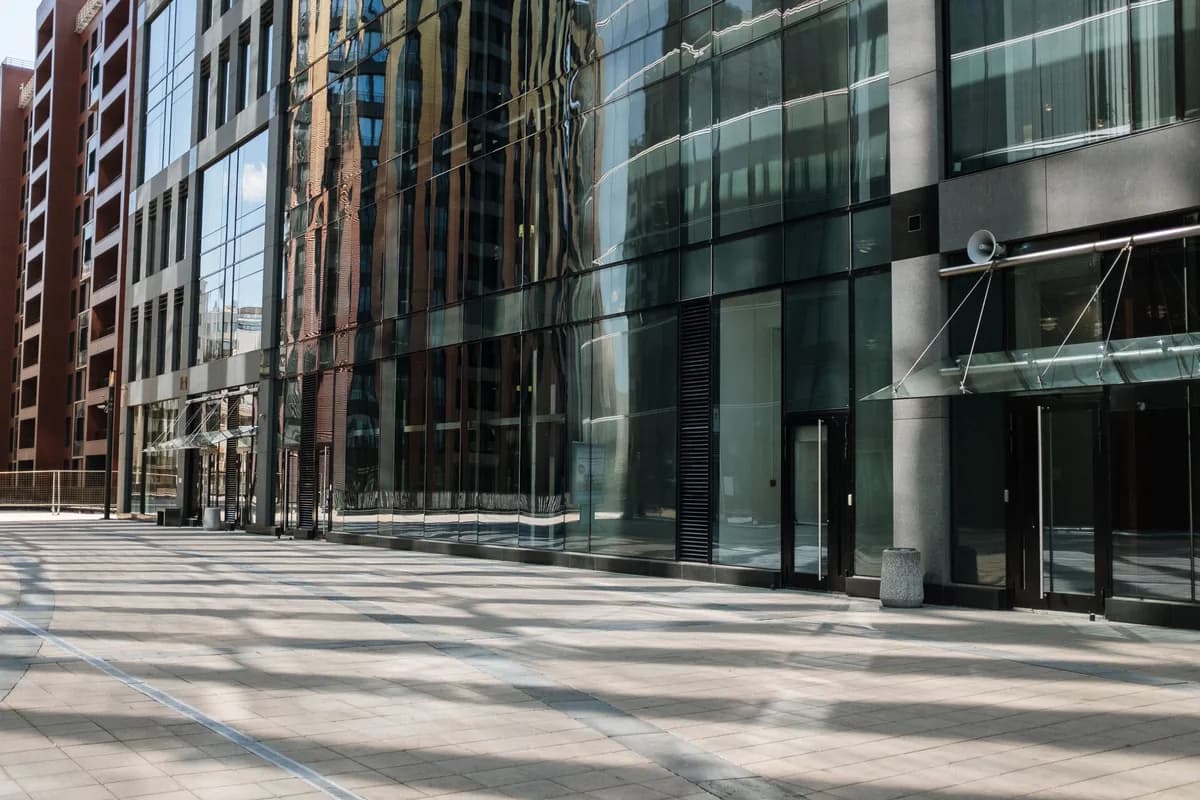 Modern glass and brick building exterior with large windows and clean facade