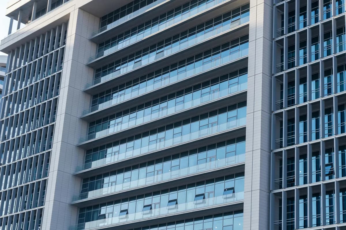Modern commercial building facade with multiple glass windows and horizontal bands