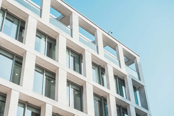 Modern residential building facade with clean windows and white exterior panels