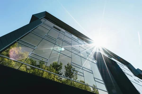 Modern commercial building with clean glass windows and green plant features