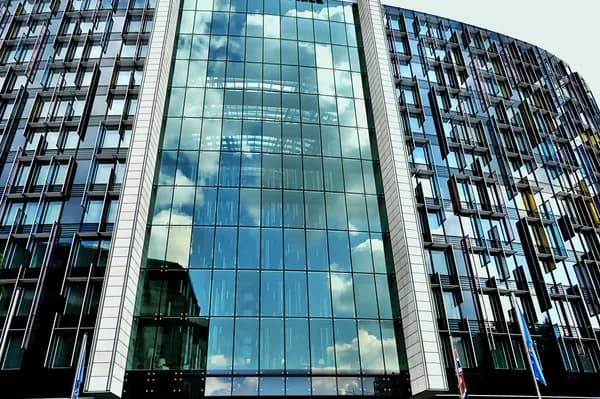 Modern skyscraper with reflective glass facade and geometric window grid pattern