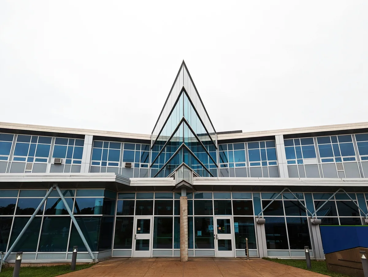Modern building facade with extensive glass windows and geometric architectural design