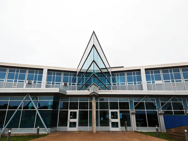 Modern building facade with extensive glass windows and geometric architectural design