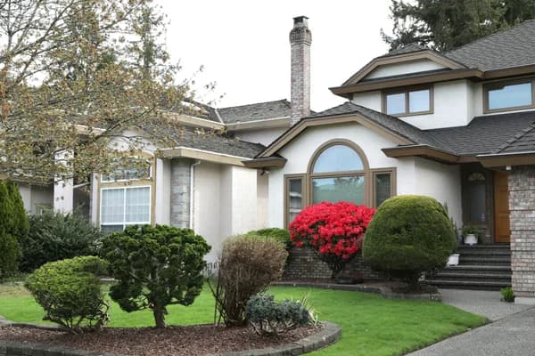 Modern two-story residential home with clean windows and manicured landscaping