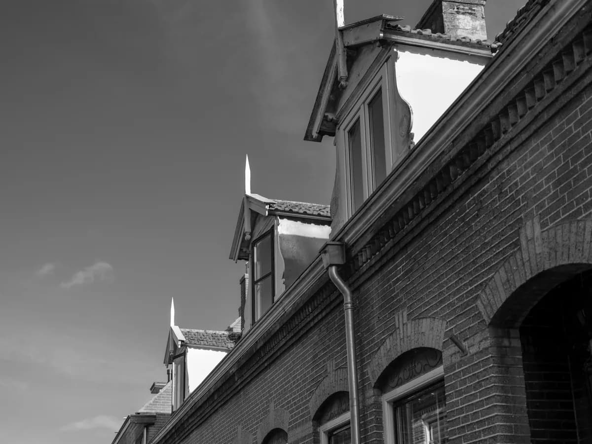 Deteriorated brick building with broken windows and damaged architectural features