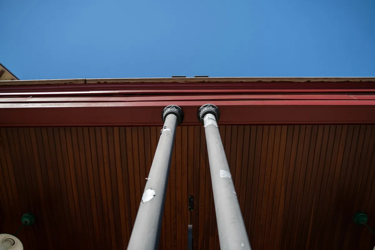 Ornamental downspouts and gutters on corrugated metal building exterior