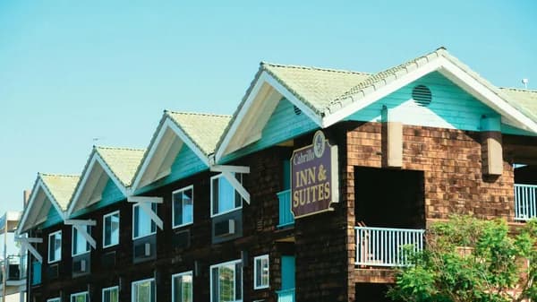 Coastal inn building with turquoise trim and shingled exterior walls