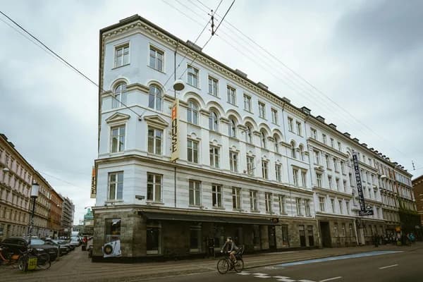 Historic multi-story building with classical arched windows and stone facade
