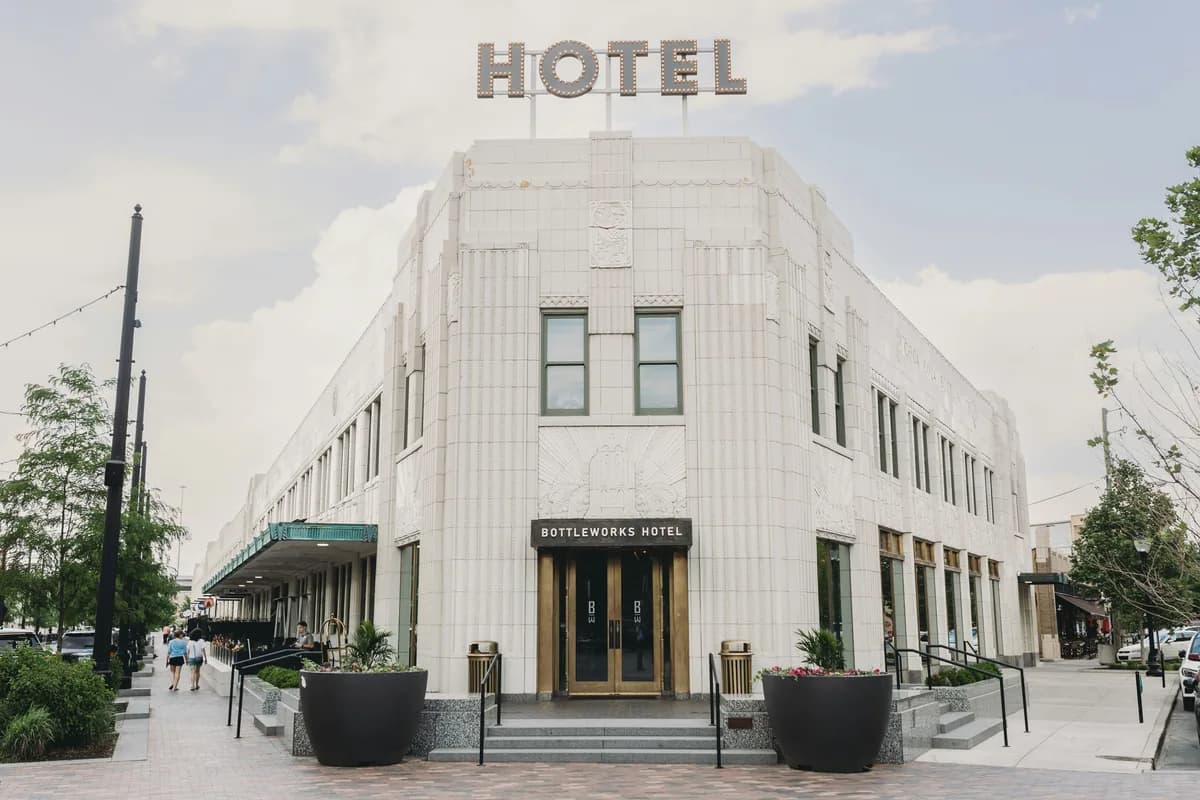 Modern white tile building facade with large windows and entrance doors
