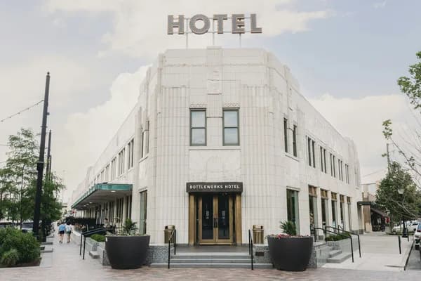 Modern white tile building facade with large windows and entrance doors