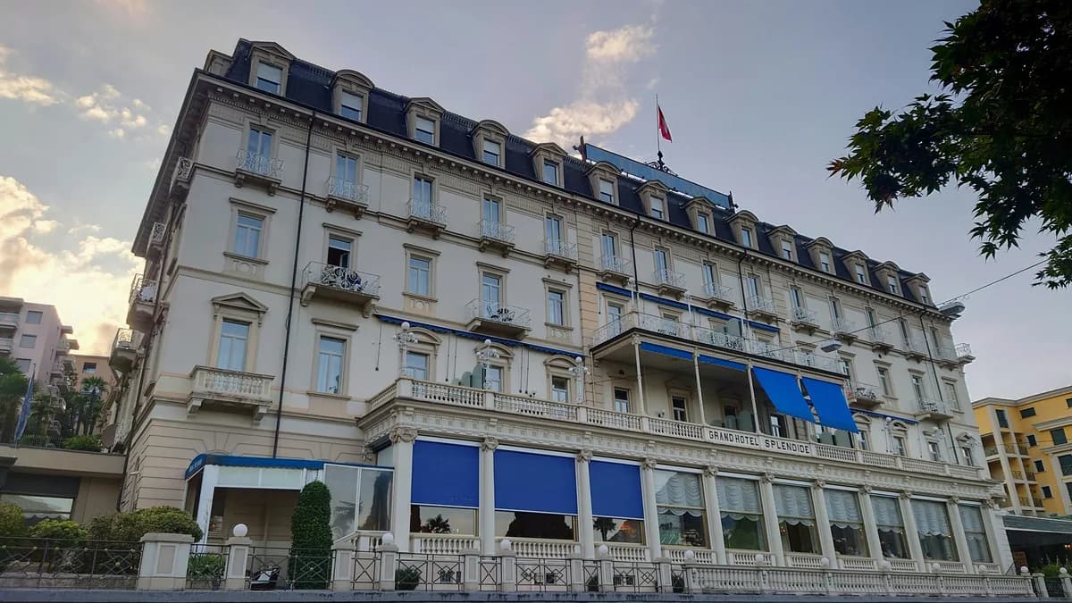 Historic multi-story hotel building with elegant mansard roof and ornate balconies