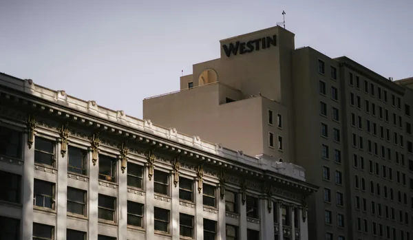 Multi-story historic building facade with rows of windows and ornate details