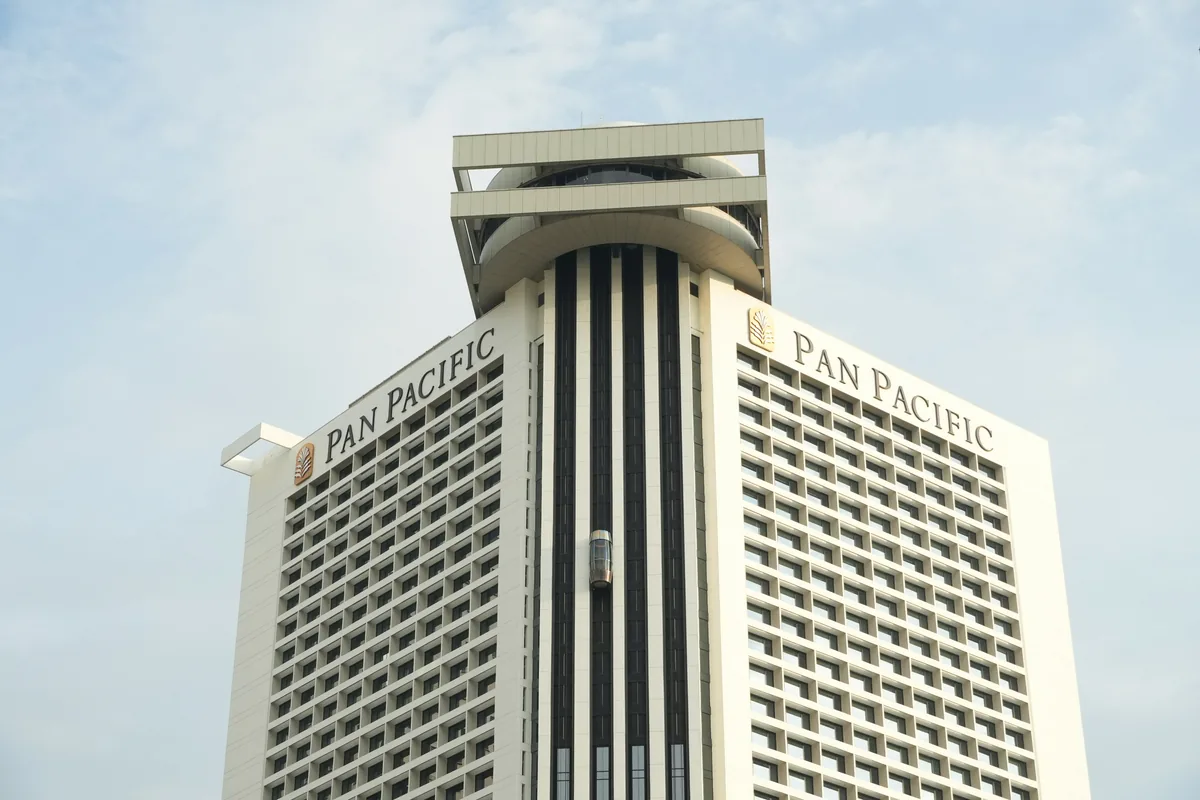 Tall hotel building with distinctive architectural tower and grid of windows
