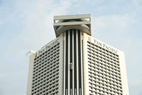 Tall hotel building with distinctive architectural tower and grid of windows
