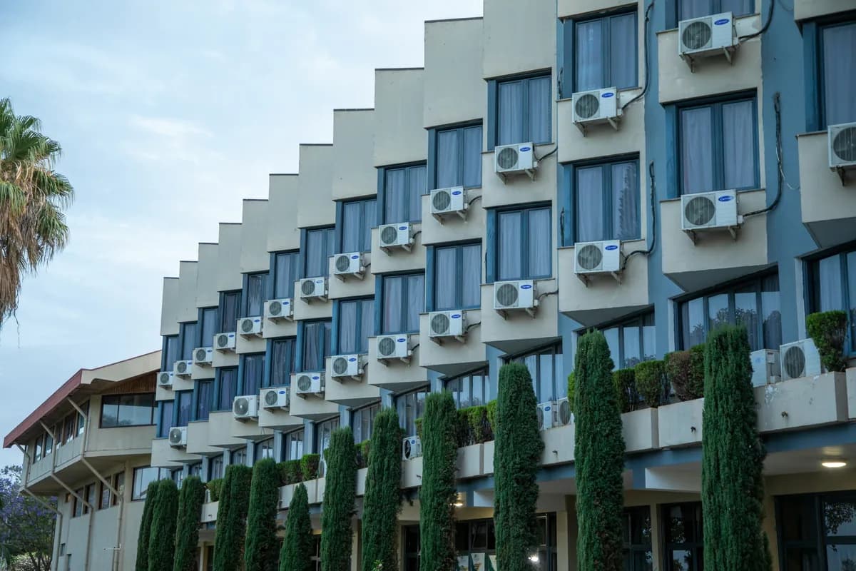 Modern stepped building facade with multiple air conditioning units and windows