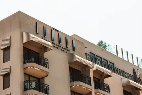 Multi-story residential building with balconies and exterior windows needing cleaning