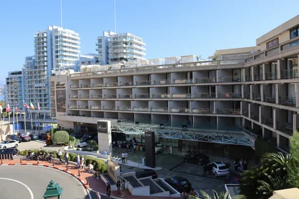 Modern multi-story residential building with numerous windows and balconies
