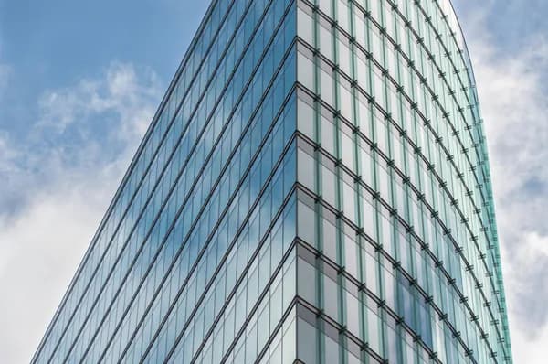 Modern glass building exterior with geometric pattern of reflective windows