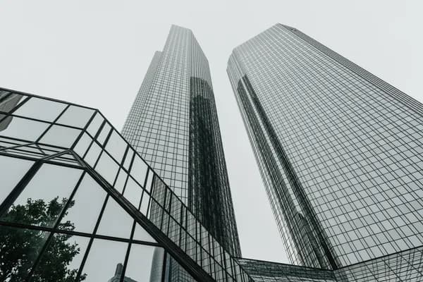 Modern glass skyscrapers with reflective windows and geometric architectural design