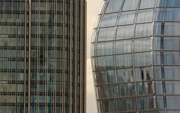 Modern skyscraper glass facades with vertical metal framing and reflective windows