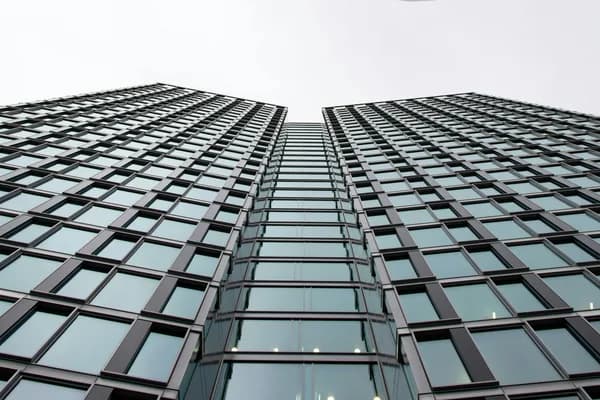 Modern skyscraper facade with grid pattern of windows and dark frames